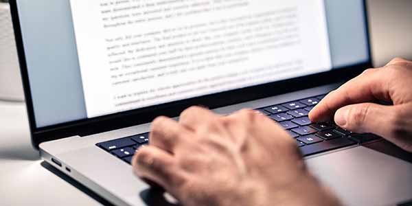 person creating content on laptop